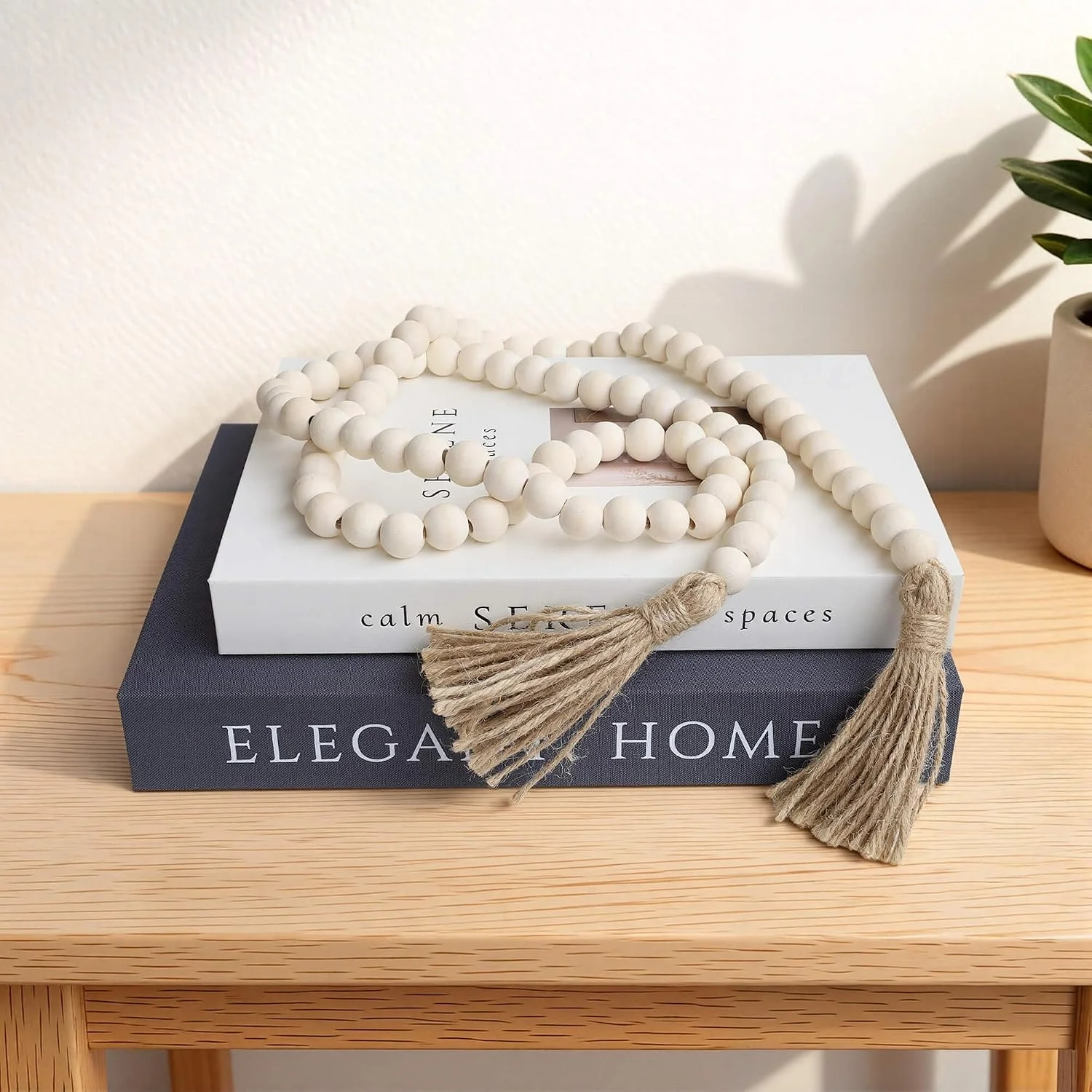 Wood bead garland with tassels, Natural Wood: garland on decorative books