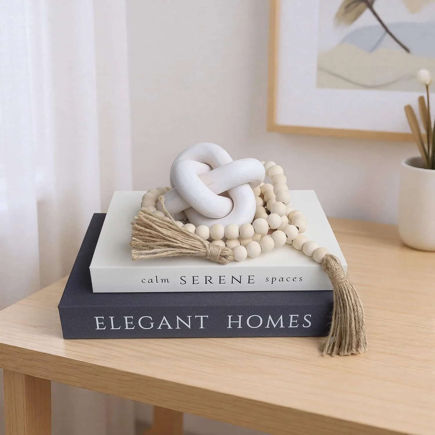 Wood bead garland with tassels, Natural Wood: beads beside a white knot sculpture