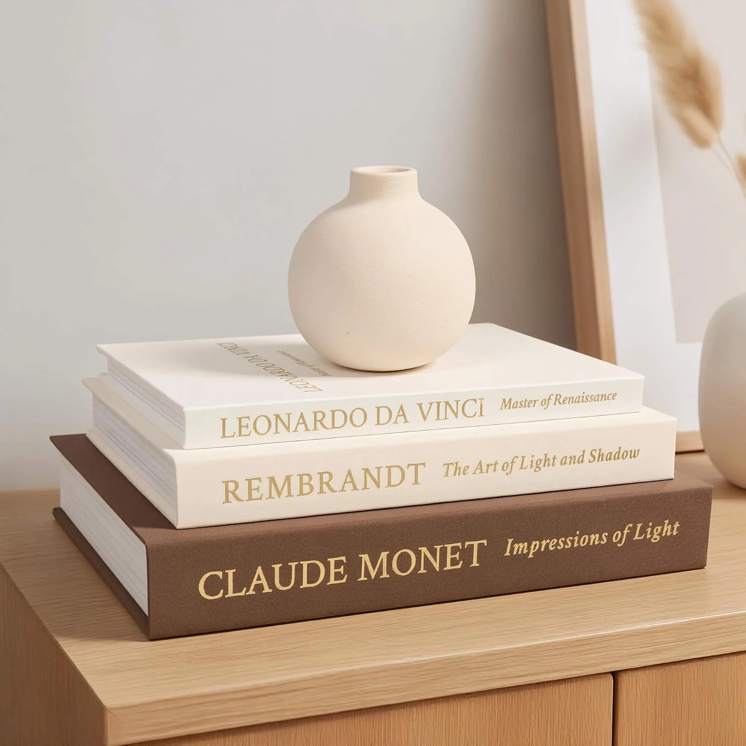 Artist trio linen storage books, Brown-Beige-White: three-book stack beneath a vase